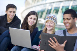 outdoor student group check out social network site on digital tablet